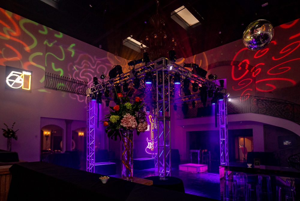 Nightclub style dance space with truss lighting and mirror ball for a birthday party at The Bell Tower on 34th, Houston, TX.
